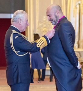 Receiving the OBE for Services to Animal Welfare by King Charles III